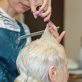 resident getting hair cut