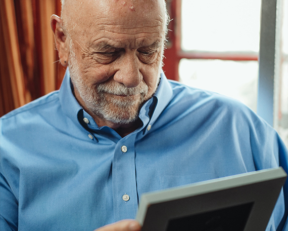 man looking at photo