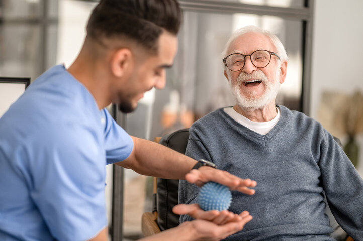 resident and nurse with sensory ball