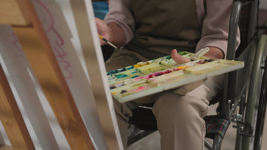 resident in wheelchair painting